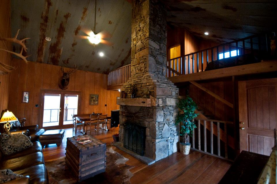 Massive stone fireplace makes this cozy cabin perfect for winter as well as summer vacations.